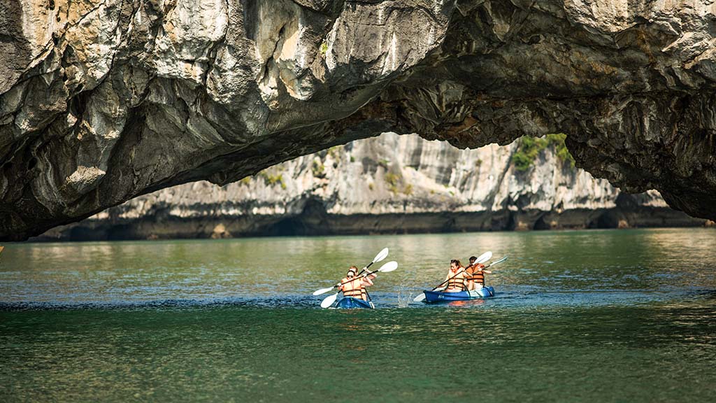 Emerald water enclosed by limestone cliffs at Ba Ham Lake, Ha Long Bay